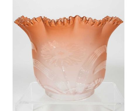 An orange glass oil lamp shade, with a frilled rim