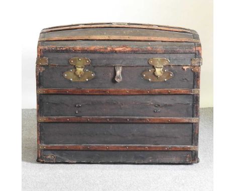 A Victorian dome top wooden bound canvas military trunk. the hinged lid fitted with a tray and drop down front revealing a fi