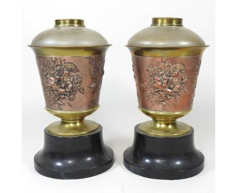 A pair of 19th century brass oil lamp bases, relief decorated with flowers, each containing a glass reservoir, 26cm high