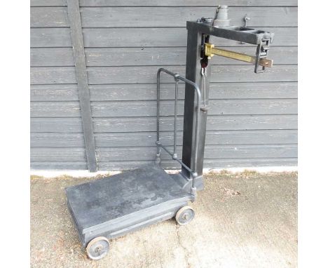 A set of black painted balance scales, with weights112cm high