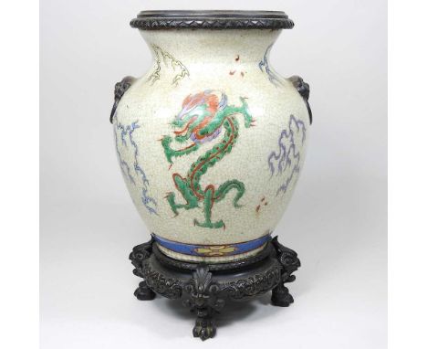 A Chinese pottery oil lamp base, decorated with birds, on a bronzed base, 29cm highOverall looks complete. The glaze is craze