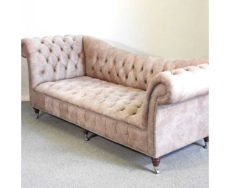 A modern hide upholstered sofa, with a curved button back, on turned legs, by Chesterfield Couture250w x 88d x 85h cm