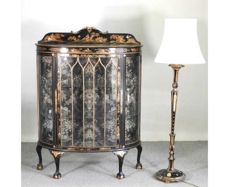 A 1920's ebonised and chinoiserie display cabinet, decorated with figures, landscapes and animals, on claw and ball feet, tog