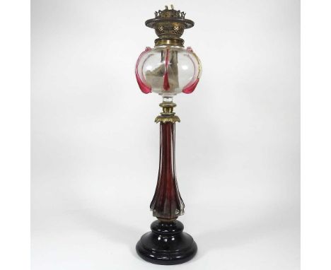 A 19th century glass and gilt metal oil lamp, the reservoir with ruby glass teardrop decoration, 58cm highGenerally dirty and