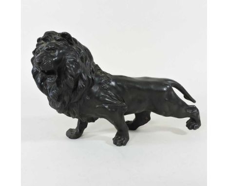 A Japanese bronze model of a lion, early 20th century, shown standing, signed to underside, 30cm longOverall looks to be comp