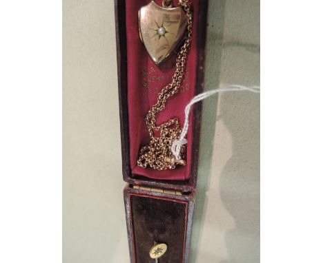 A yellow metal stick pin stamped 15ct and a 9ct rose gold belcher chain with rolled gold heart shaped locket 