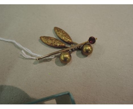 A yellow metal bar brooch stamped 9c having a ruby stone and a pair of rolled gold cufflinks of lozenge form having moulded d