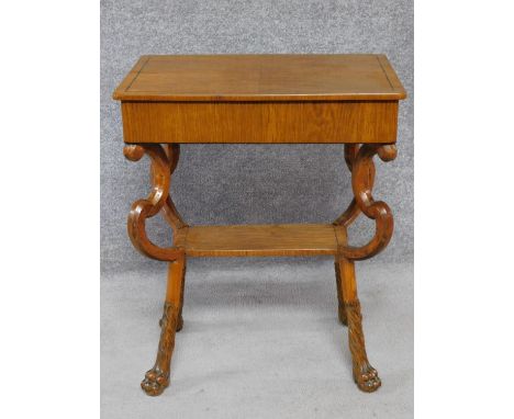 A 19th century Continental ebony line inlaid lamp table on shaped cabriole lion paw supports. H.69 L.54 W.36cm 