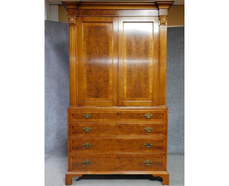 A Georgian style yew and walnut crossbanded armoire with panel doors above four graduating drawers on bracket feet. H.220 W.1