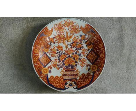 A large Chinese/Japanese hand painted Imari charger with floral and phoenix motifs. Six character seal mark to reverse. 47x47