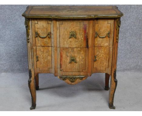 A 19th century Continental walnut two drawer commode with ormolu edges and mounts and allover satinwood floral inlay set with