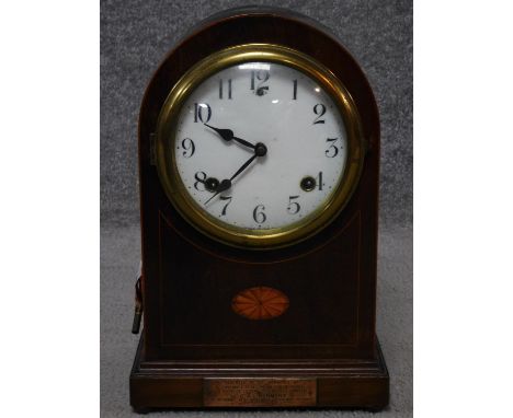 An F S antique mahogany and satinwood inlaid mantle clock, with brass dedication panel, brass banding and button feet and whi