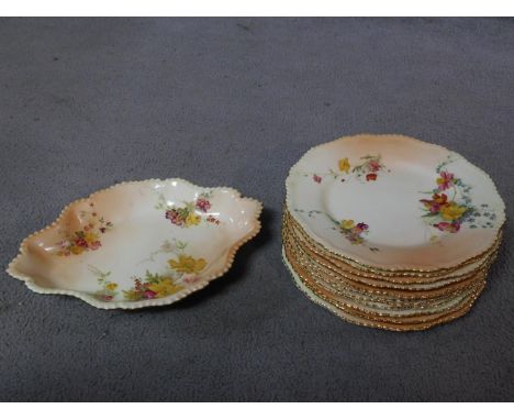 A set of eleven 1898 Royal Worcester hand painted floral design on blush ivory porcelain dinner plates and matching serving d