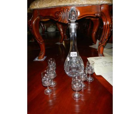 A cut glass decanter and six glasses.