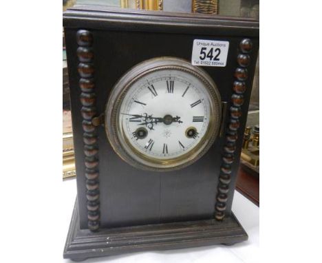 An early 20th century oak cased mantel clock.