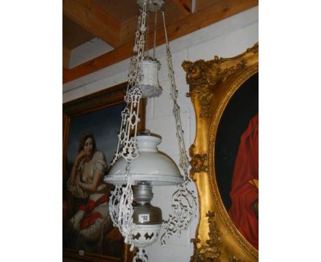 A wrought iron hanging oil lamp with shade, COLLECT ONLY.