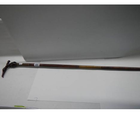 A carved mahogany walking stick.