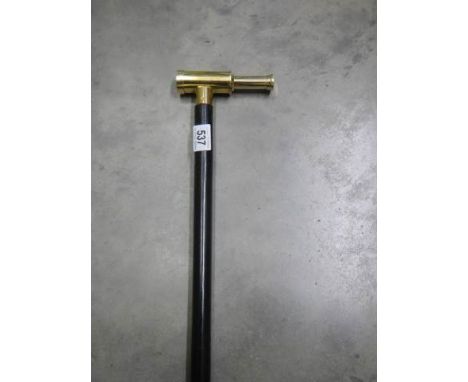 A modern walking stick with brass telescope as the handle.