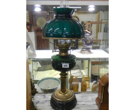 A Victorian brass oil lamp with green glass font and green glass shade, COLLECT ONLY.