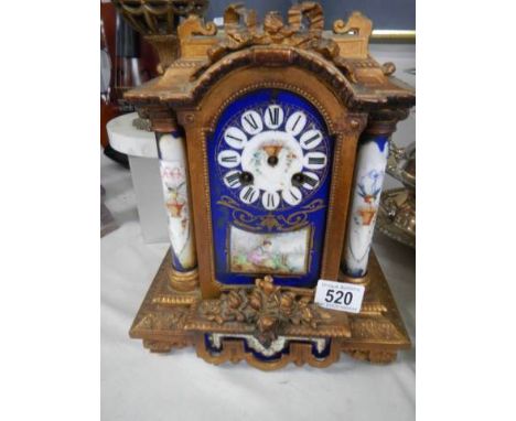 A late 19th century French mantel clock with Sevres panels, spring ok but missing hands.No Key.No pendulum.Missing finial off
