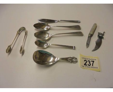 A silver caddy spoon, 3 silver spoons, silver sugar nips, silver book mark, silver penknife etc.,
