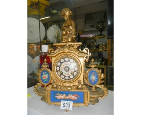 An old French mantel clock with Sevres panels, in working order.