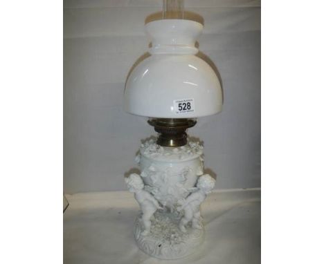 A superb quality white glazed porcelain oil lamp surmounted with cherubs and with drop in font, COLLECT ONLY.