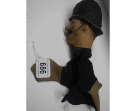 A vintage hand puppet of a policeman.
