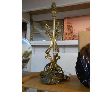 A mid 20th century cast brass table lamp base, 50 cm tall.