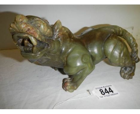 A powerful Chinese jade figure of a mythical lion. H 13cm x&nbsp; W 20cm.&nbsp;