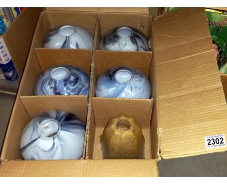 A box containing 6 lamp shades