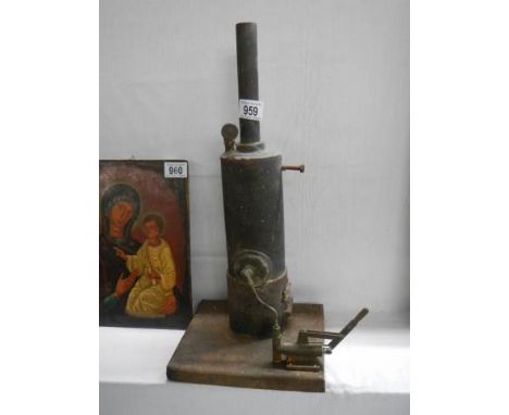 A vintage vertical copper steam engine.