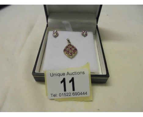 A yellow gold diamond and ruby pendant and earring set, 3.6 grams.Pendant has full hallmark stamped 375 on chain loop