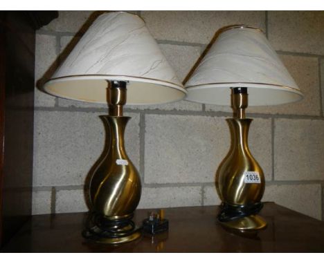 A pair of gilded ceramic table lamps.