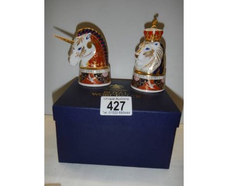 A boxed pair of Royal Worcester candlesnuffers - The Lion and The Unicorn.