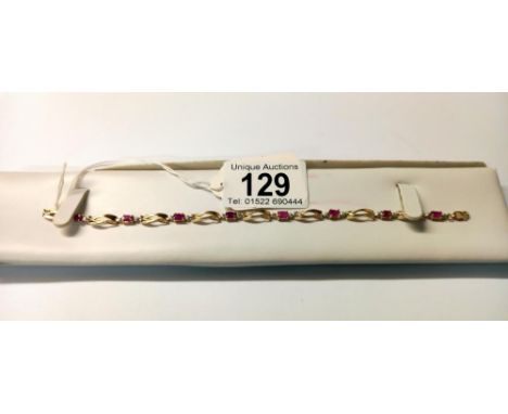 A ruby bracelet with eight rubies set in 10ct gold stamped, Birthstone for July.