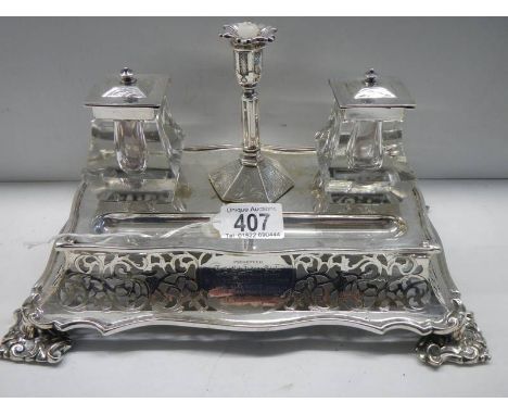 A 19th century silver plate ink stand with glass inkwell, dated 1860.Stand has minor wear to silver plate on flat surfaces.Ca