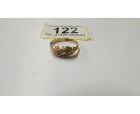 An 18ct gold diamond and ruby ring, size O, 2,2 grams.Marked Birmingham 2016Red stones still sharp.No chips.Matt surface.