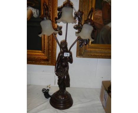 A three light figural table lamp. COLLECT ONLY.