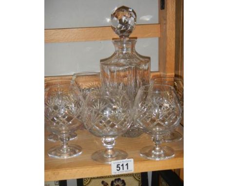 A cut glass decanter and a set of six cut glass brandy goblets.