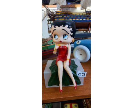 A Betty Boop cast iron singing figure in a sitting position to display on a shelf