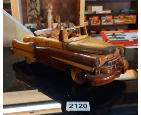 A 1/18? scale polished hard wood model of a 1950's CadillacLooks possibly shop bought.In good condition.Length 30cm