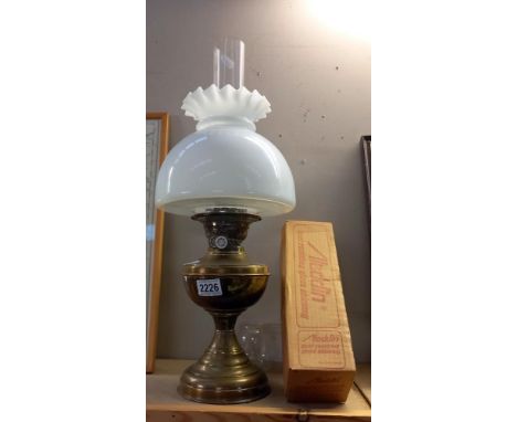 A vintage brass oil lamp and shade, plus a boxed Aladdin Loxon chimney