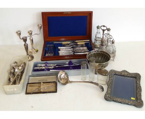 Silver "Rye" drinks label, a small candelabra and candlestick (weighted) a silver front frame, three silver topped glass bott