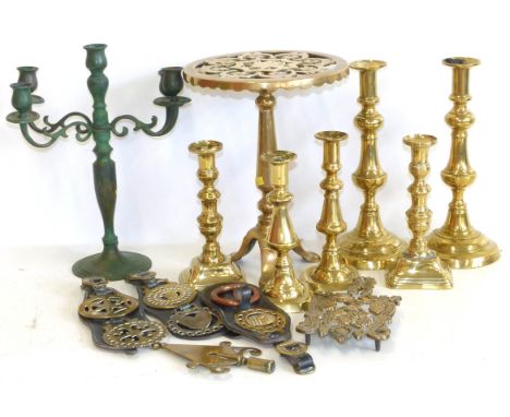 Victorian pierced brass circular trivet, 24cm diameter on tripod base, three pairs brass candlesticks, three pairs horse bras