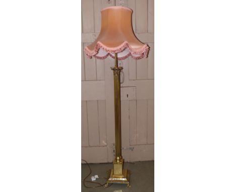 Brass Corinthian column standard lamp complete with pink shade. Condition reports are not available for the Interiors Sales.