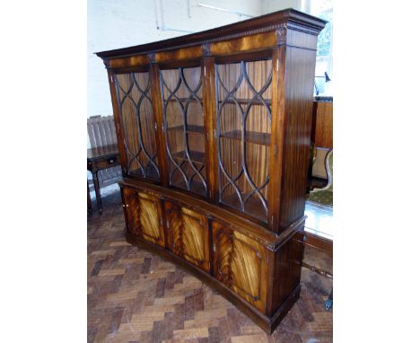 Reproduction mahogany inverted bow fronted bookcase with glazed upper portion and cupboard to base 173cm wide Condition repor