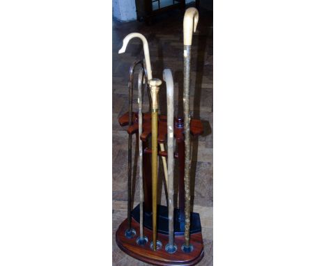 A collection of seven walking sticks and a modern stick stand Condition reports are not available for the Interiors Sales.