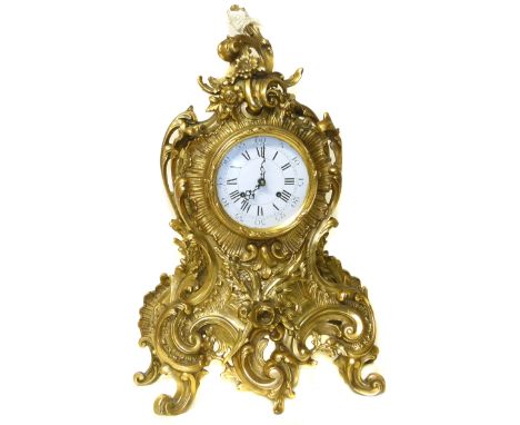 A reproduction Rococo style brass mantel clock Condition reports are not available for the Interiors Sales.