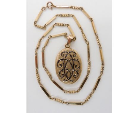 A 9CT LOCKET WITH ENAMELED DETAIL AND FANCY CHAINthe locket has London import marks for 1983, and thorny branches picked out 